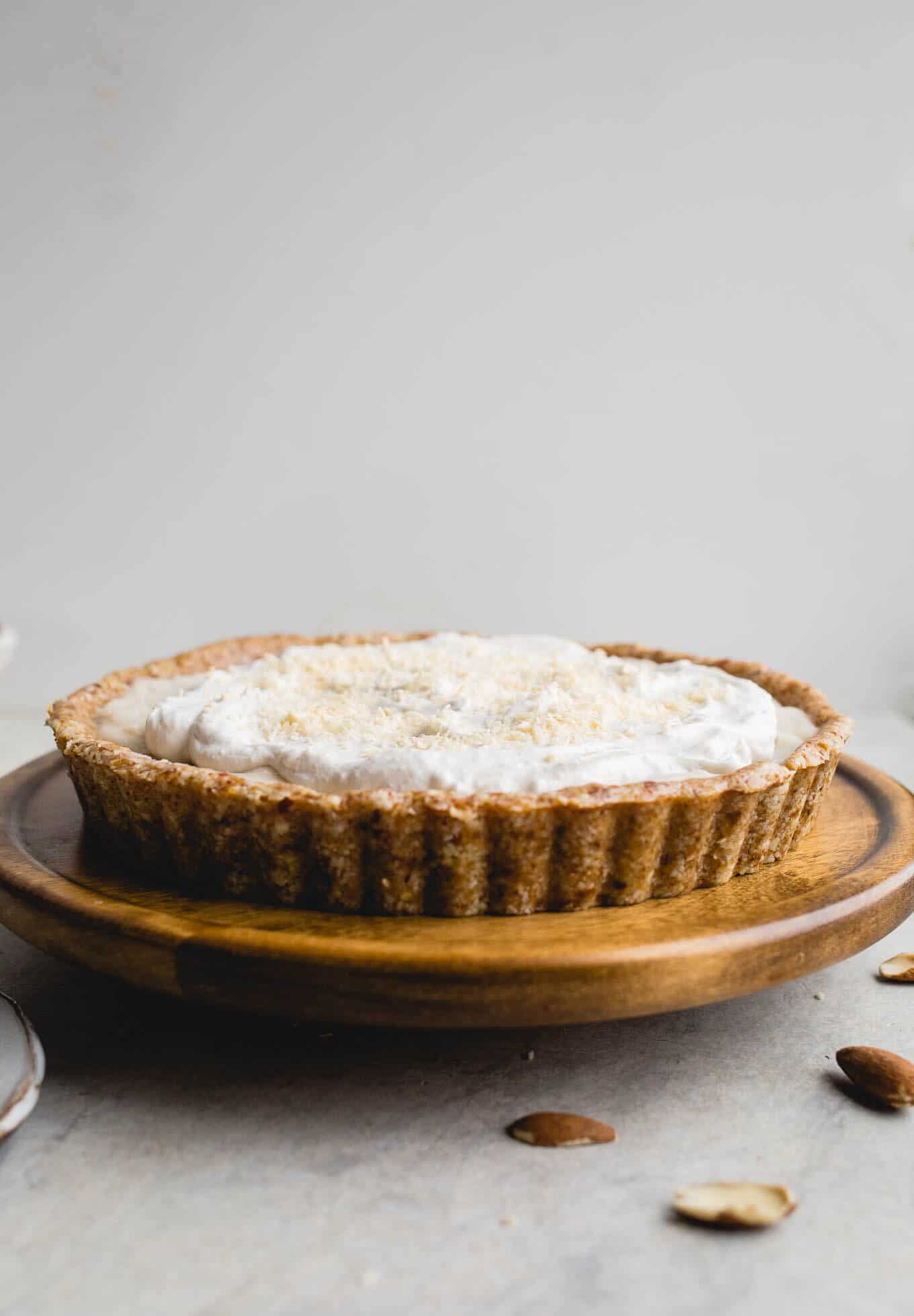 This No-Bake Coconut Cream Pie is made with a sprouted almond press-in crust, coconut milk pudding filling, and topped coconut cream and toasted shredded coconut. Gluten-free, vegan.