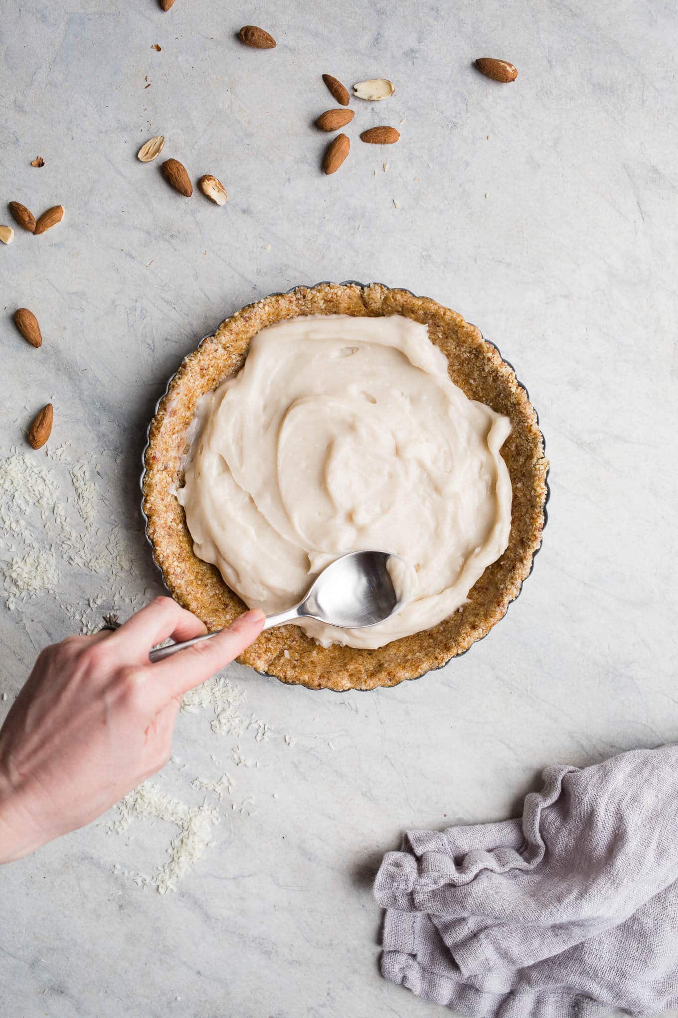 This No-Bake Coconut Cream Pie is made with a sprouted almond press-in crust, coconut milk pudding filling, and topped coconut cream and toasted shredded coconut. Gluten-free, vegan.