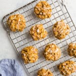 Oatmeal cookies with carrots on a wire rack.