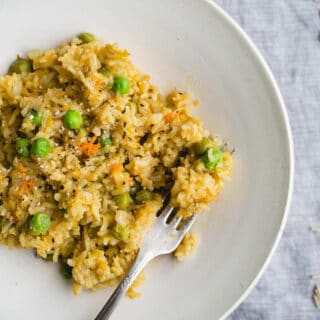 Brown Rice Risotto with Peas and Carrots is a one-pot meal made with simple ingredients. Gluten-free, vegan.
