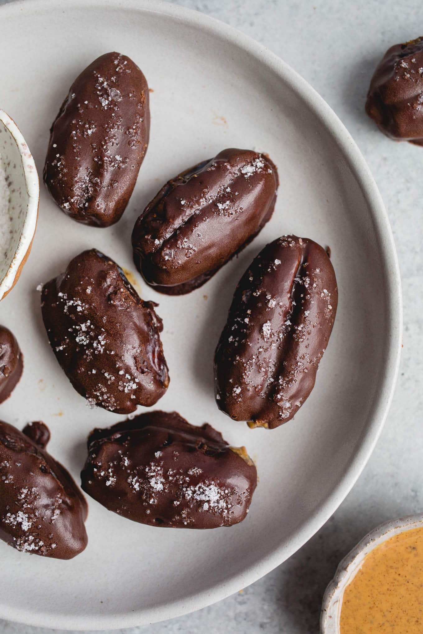 Chocolate covered dates on a gray plate.