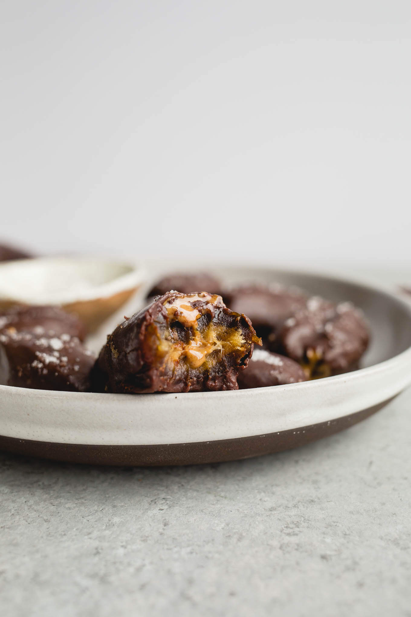 These Chocolate-Covered Almond Butter Stuffed Dates topped with sea salt are gluten-free, vegan, and refined sugar-free. Perfect for a snack or dessert!