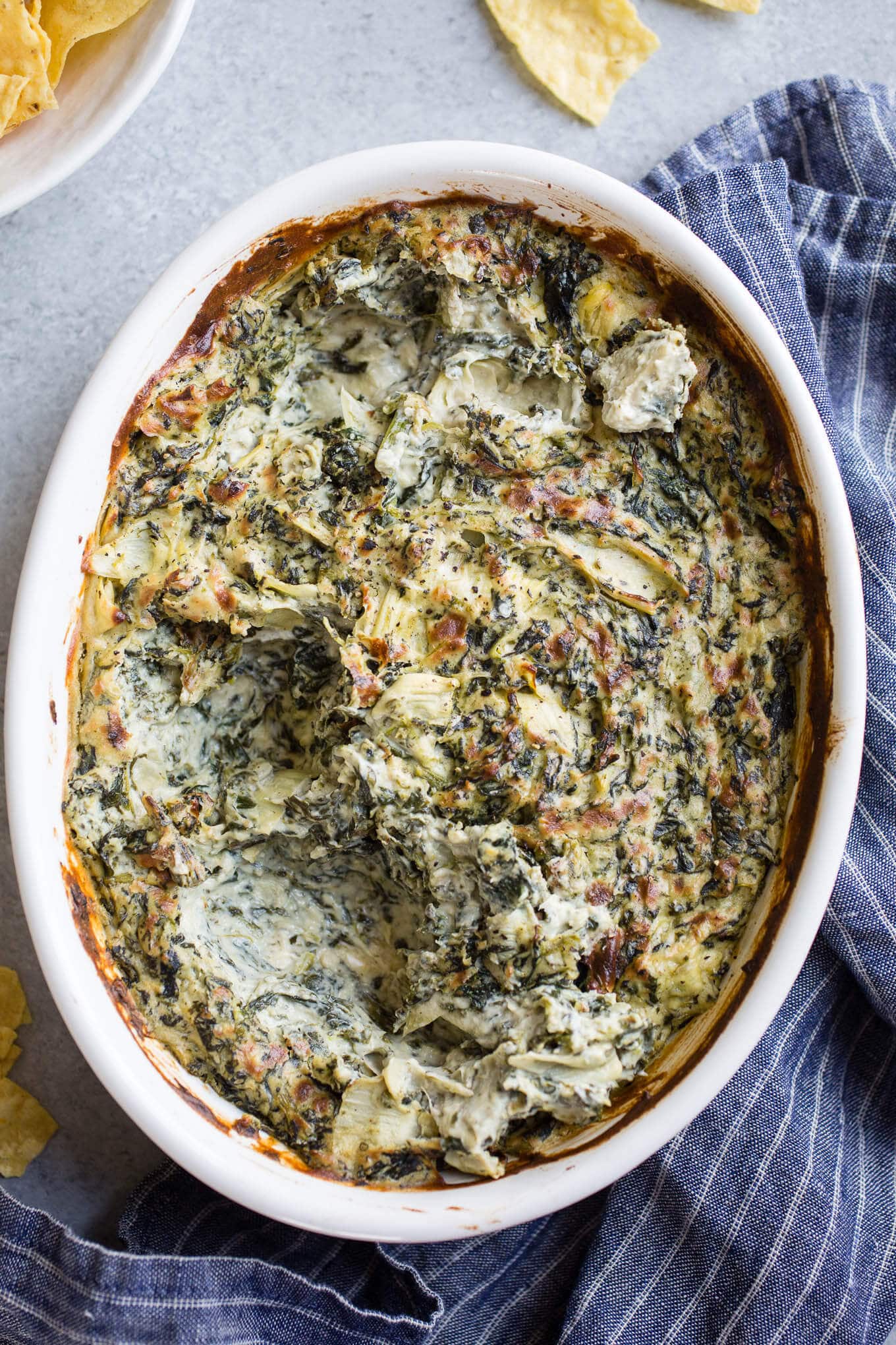 Spinach dip in a white baking dish.