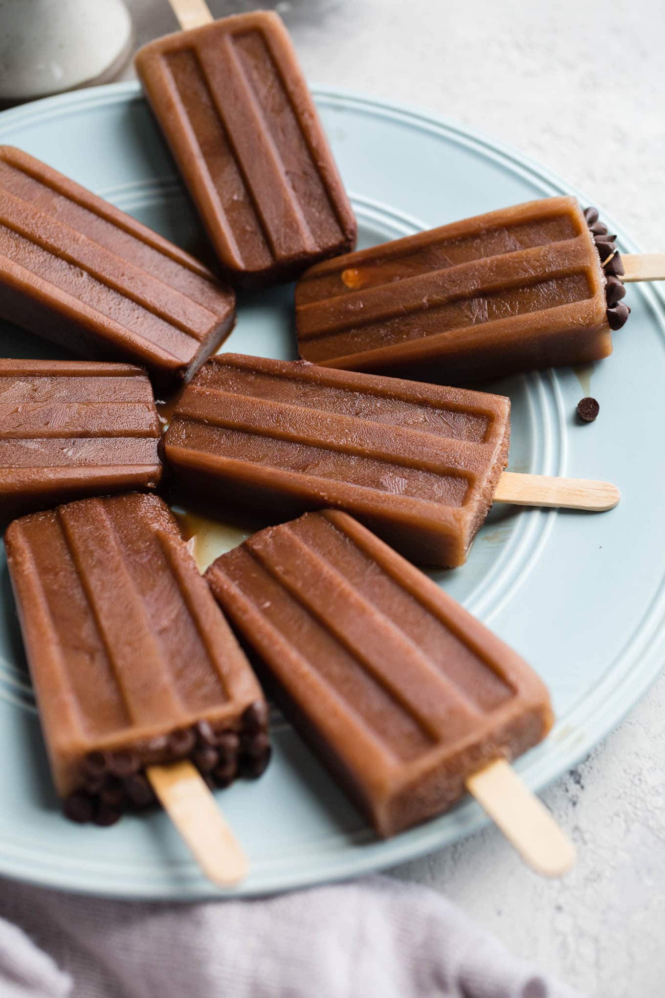 Mocha Iced Coffee Popsicles combine unsweetened cocoa powder, coffee, and almond milk, and honey for cool and creamy healthy frozen treat.