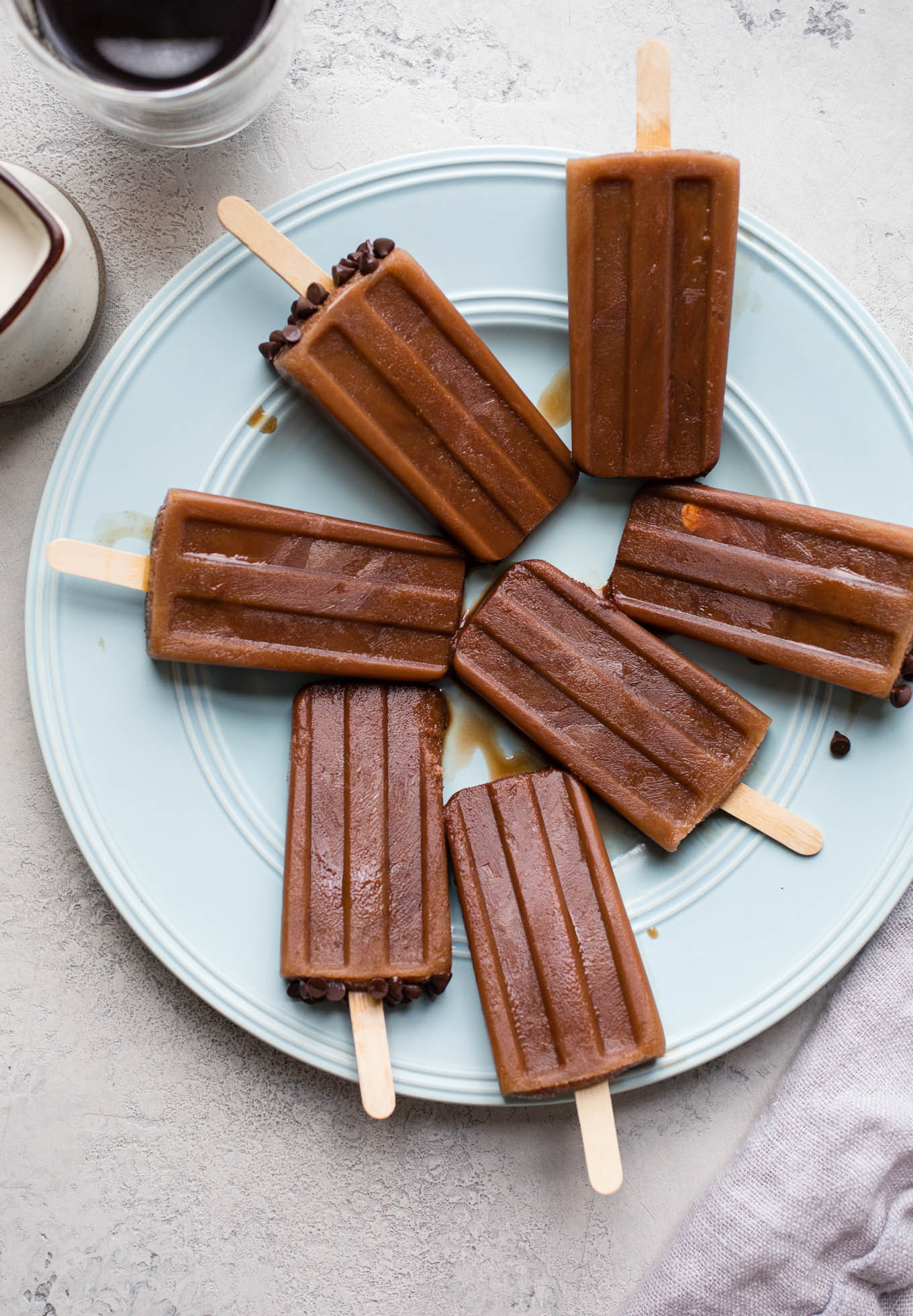 Mocha Iced Coffee Popsicles combine unsweetened cocoa powder, coffee, and almond milk, and honey for cool and creamy frozen treat.
