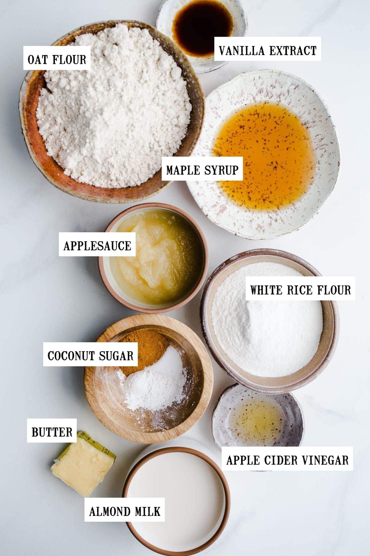 Ingredients to make oat flour pancakes in small bowls. 