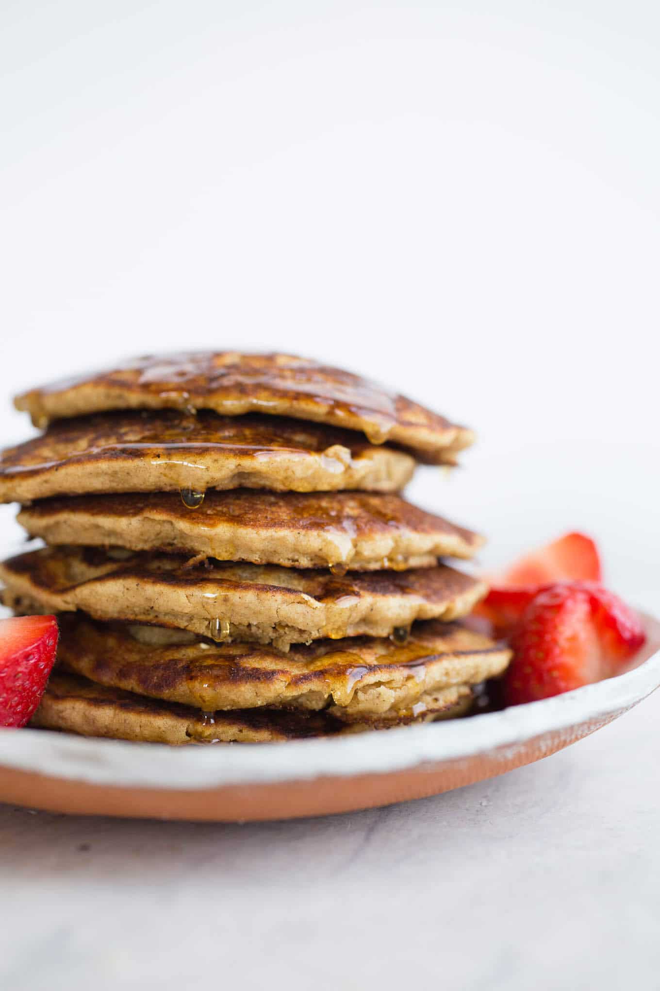 Gluten-free Vegan Oat Flour Pancakes made with whole grain gluten-free oats, white rice flour, applesauce, and non-dairy buttermilk, for a light and tender crumb. An oat flour pancake recipe made without eggs or bananas. Easy and delicious!