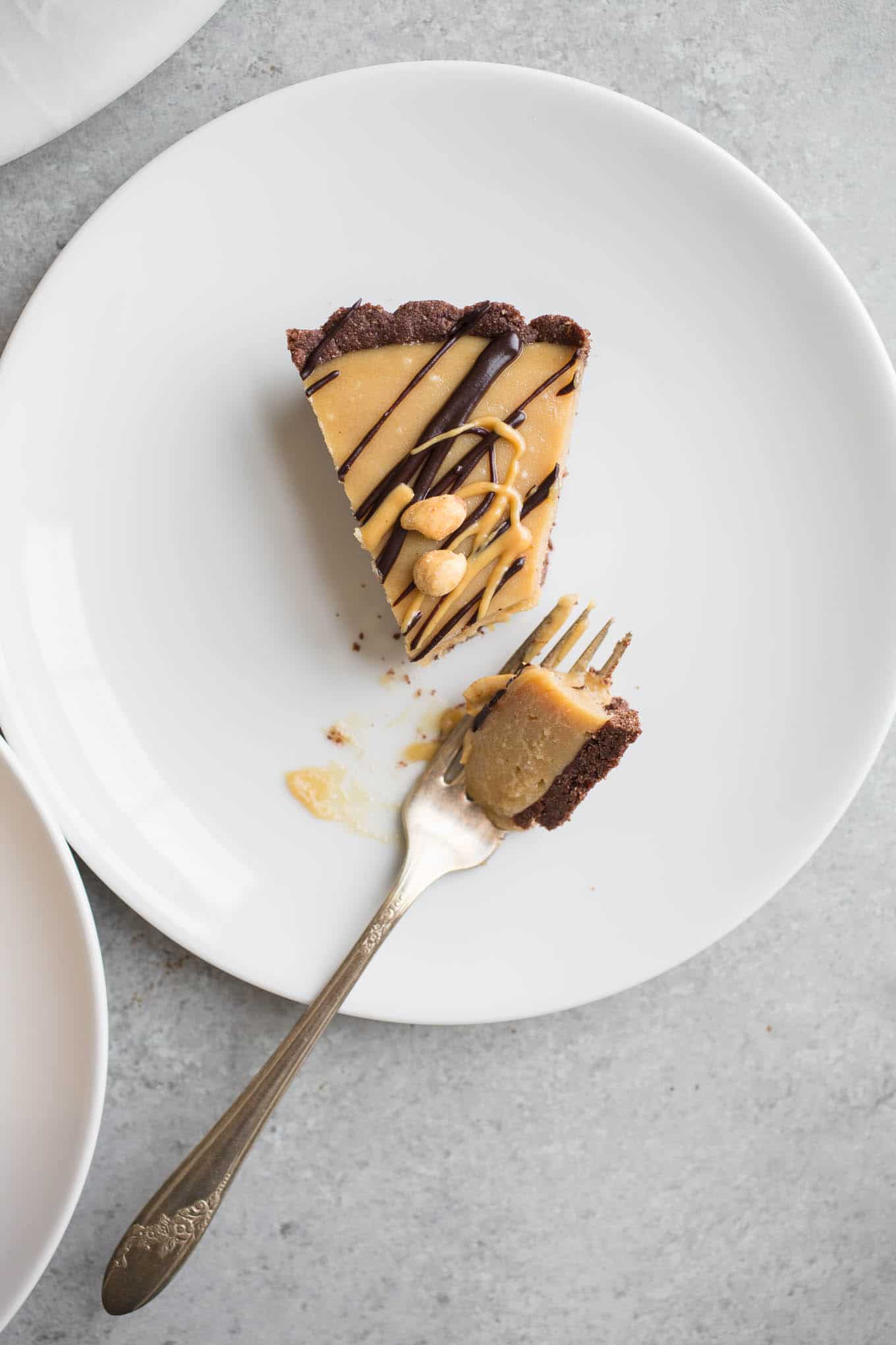 Vegan Peanut Butter Pie made with all-natural peanut butter, coconut milk, and maple syrup in a chocolate almond flour crust. A gluten-free frozen dessert recipe without refined sugar.