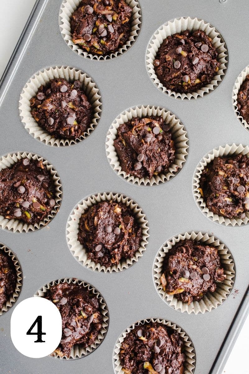 Chocolate batter in a muffin tin cups.