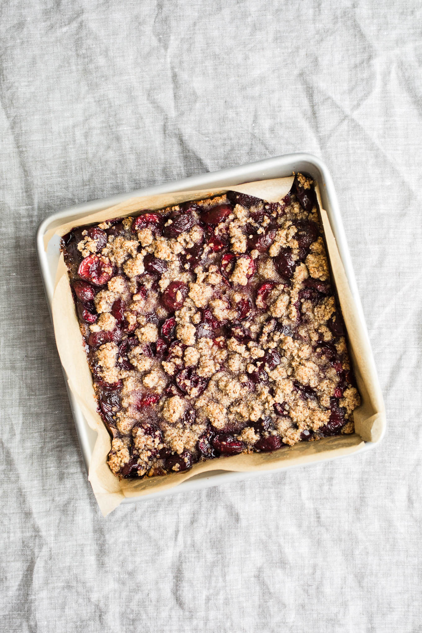 Gluten-Free Cherry Crumble Bars that use fresh cherries, wholesome almond flour, and unrefined coconut sugar. Part cherry pie, part coffee cake, all good! Vegan too. 