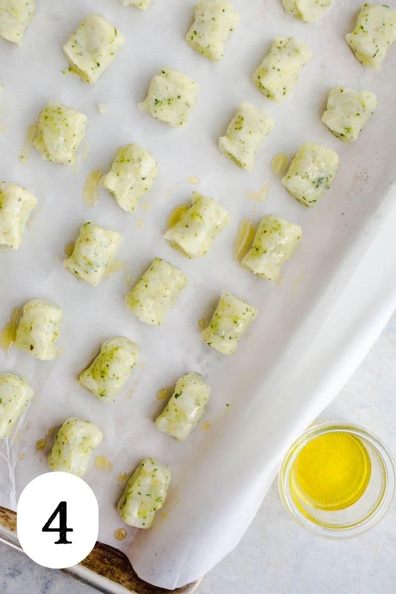 Zucchini tots lined evenly on a baking sheet.