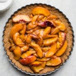A peach tart on a cookie crust.