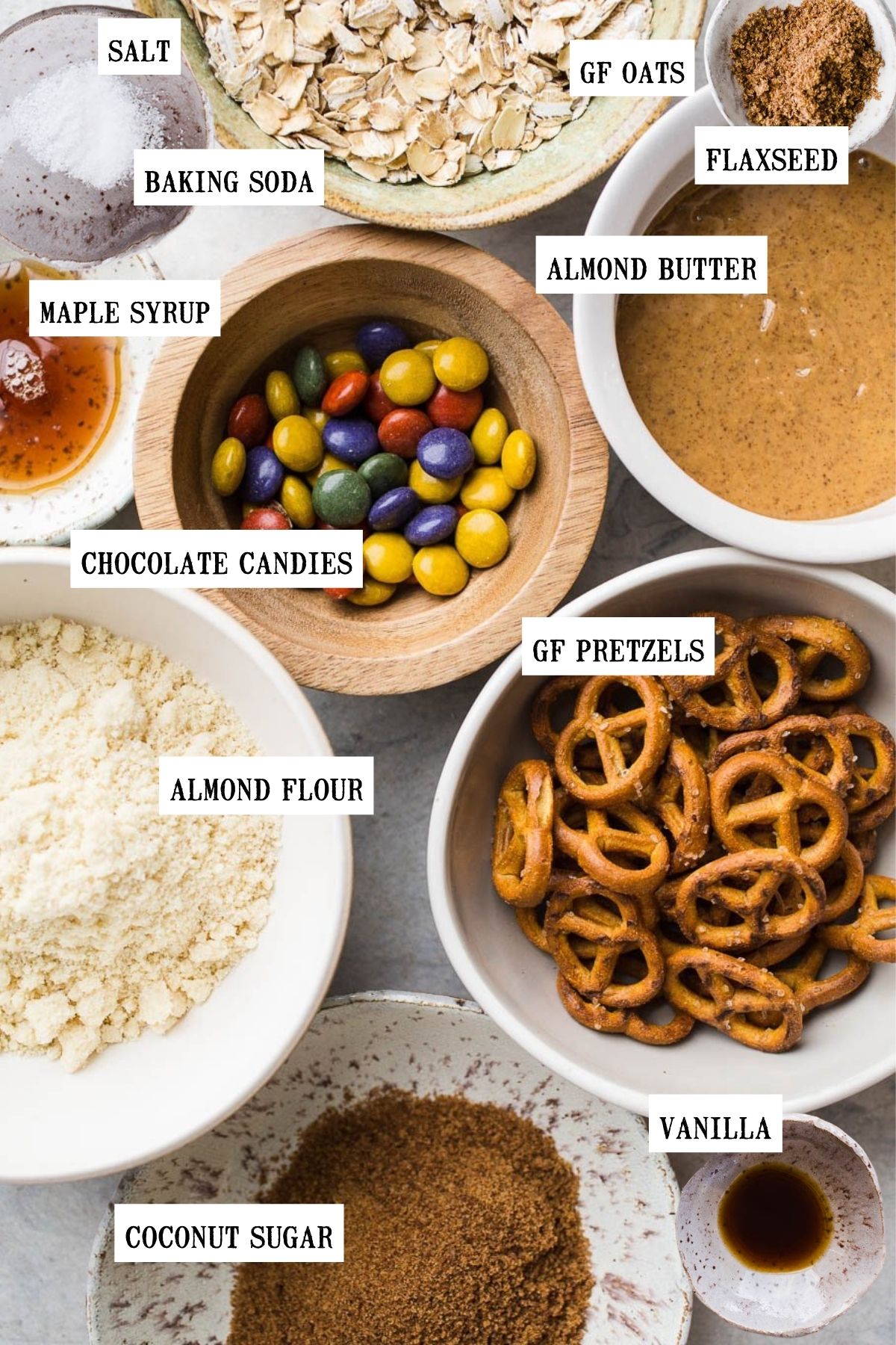 Ingredients in a variety of small bowls to make monster cookies. 