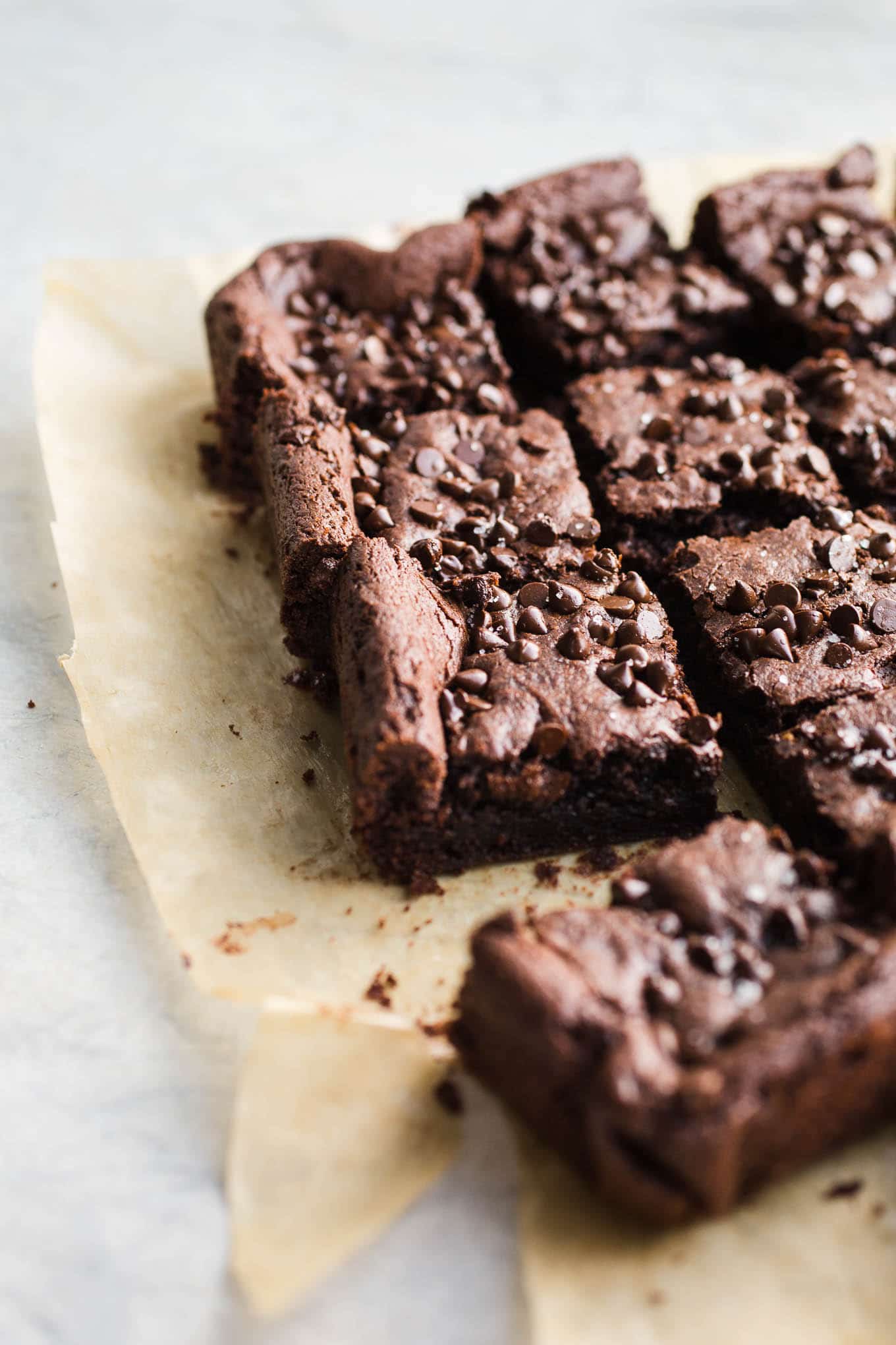 Sliced brownies on parchment paper. 