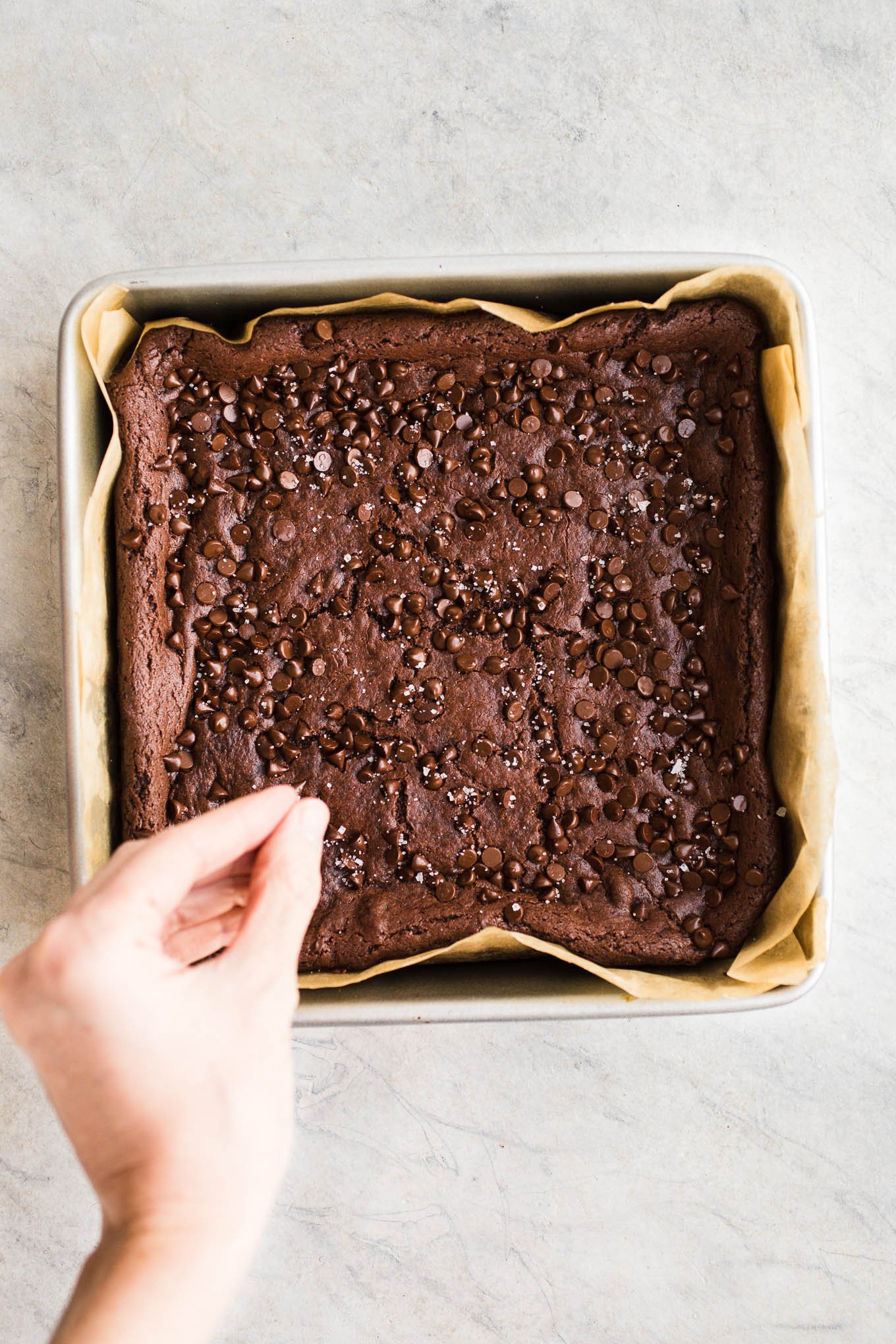 Vegan Tahini Brownies made with rich cocoa powder, tahini, maple syrup, chocolate chips, and sea salt. Gluten-free. 
