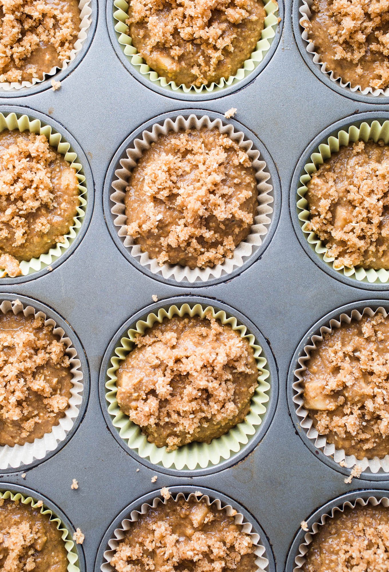 Gluten-Free Apple Crumb Muffins are made with whole grain gluten-free oat flour, almond flour, applesauce, and coconut sugar topped with a cinnamon sugar crumble. Dairy-free, vegan.