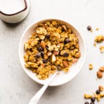 Granola with almonds in a white bowl.