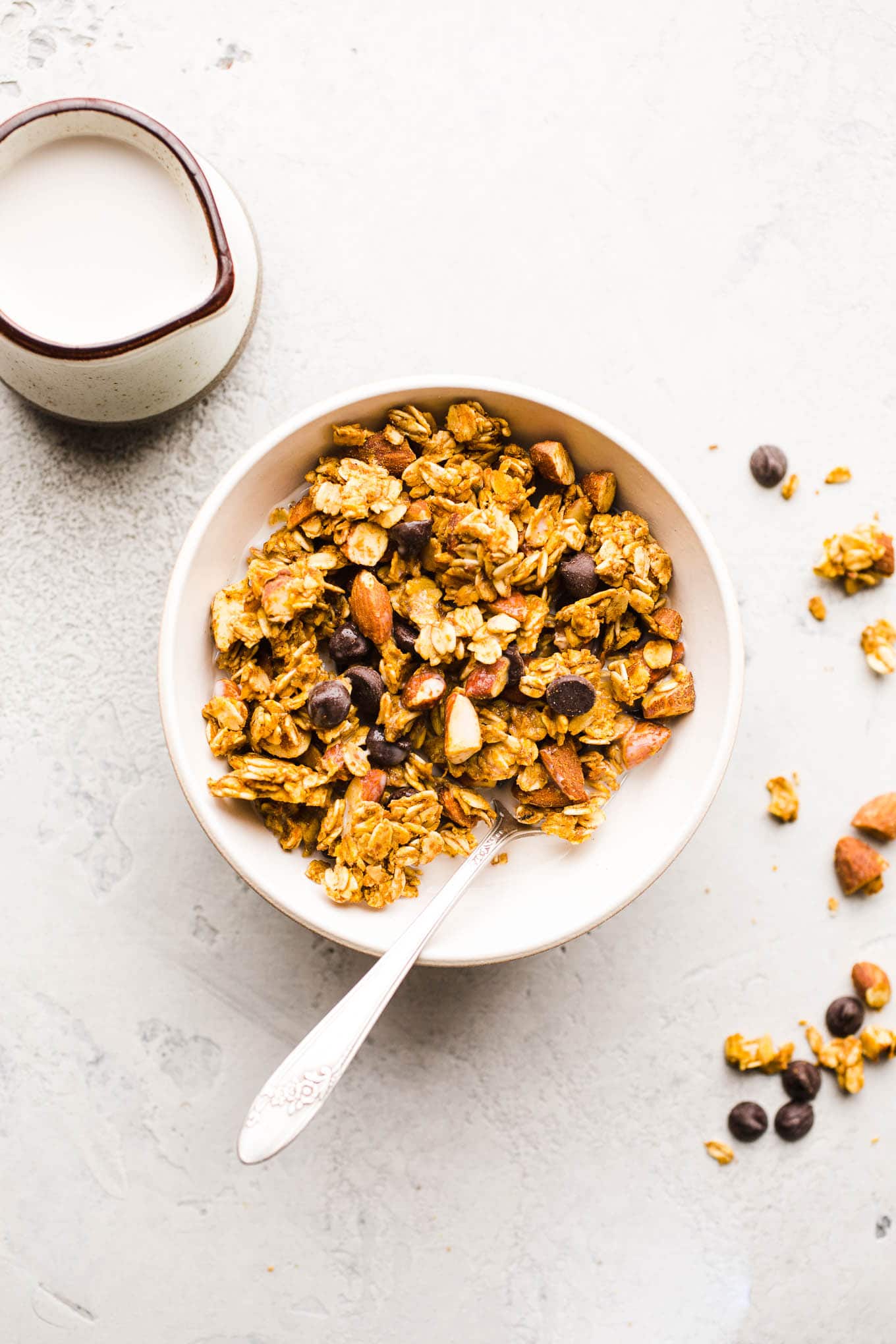 Granola with almonds in a white bowl.