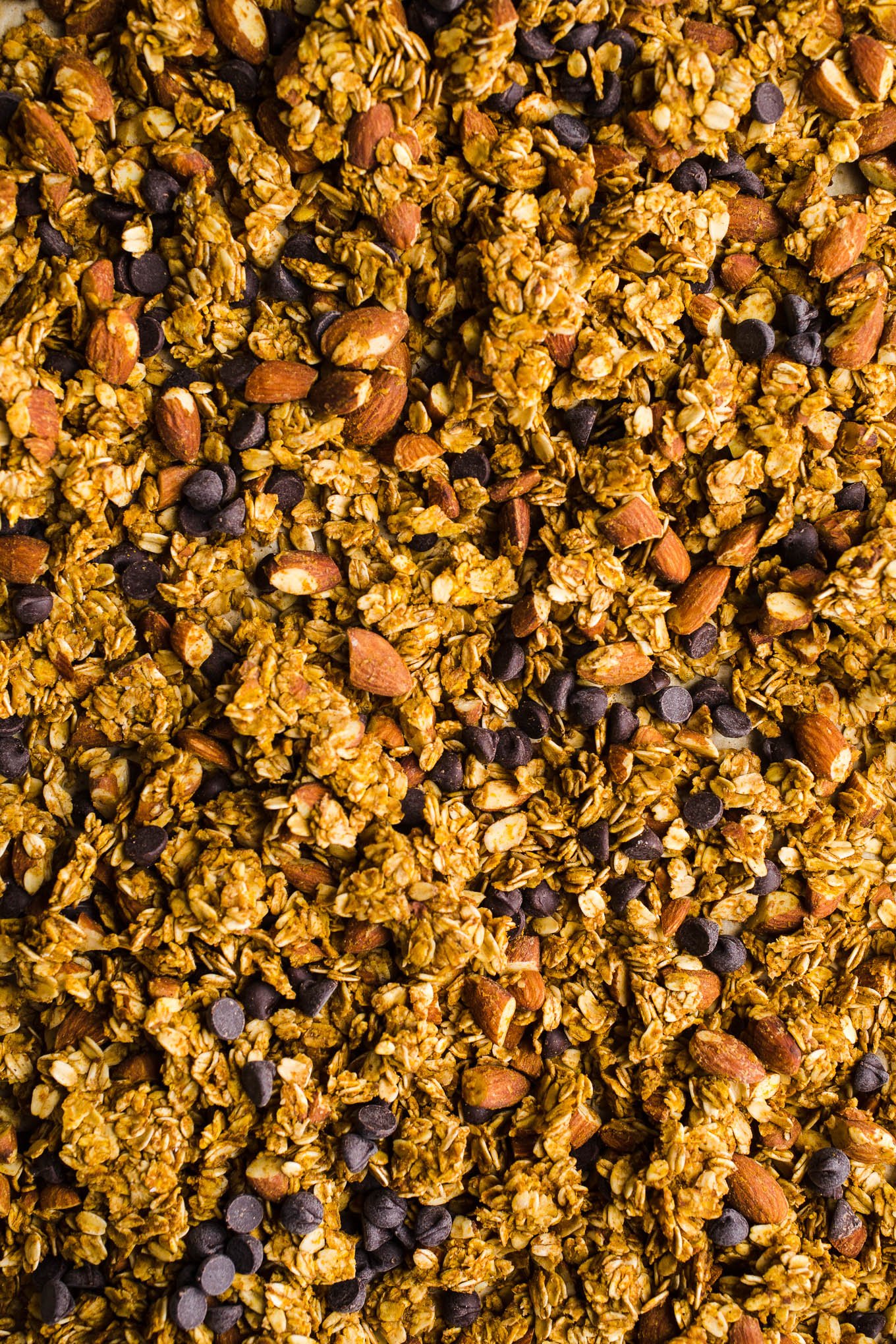 Clumpy granola on a baking sheet.