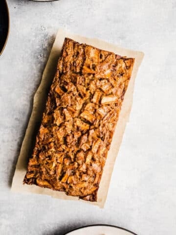 Apple cake on a piece of parchment paper.