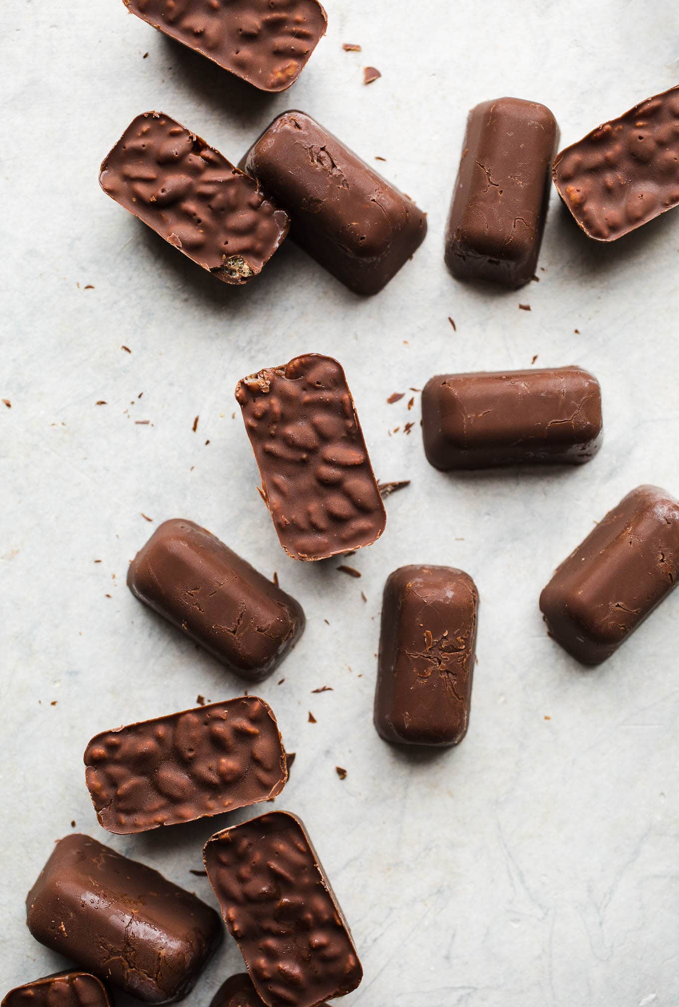Homemade Mini Crunch Bars made with dairy-free chocolate, gluten-free rice cereal, and coconut oil. Use a standard ice cube tray to make these individual serving chocolate crunch treats!