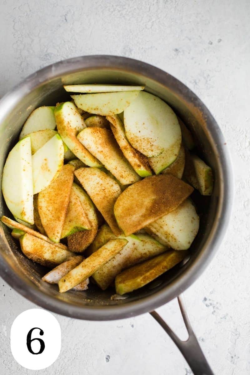 Apple slices and cinnamon in a large saucepan.