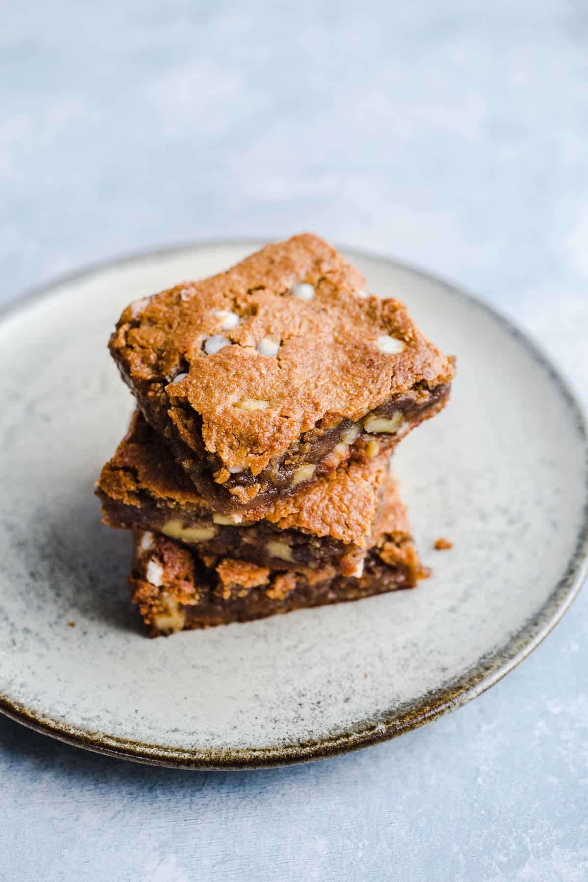 Blondies squares stacked on a plate. 