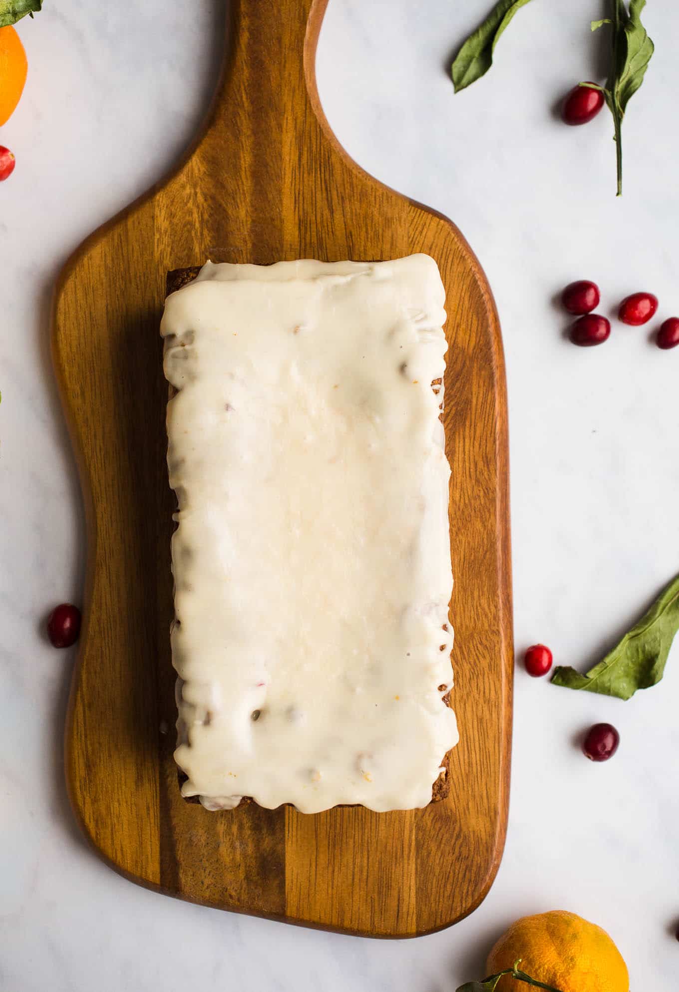 A healthier, moist, Gluten-Free Cranberry Orange Bread with an orange glaze made with almond and oat flours. Vegan. Have it for breakfast or dessert!