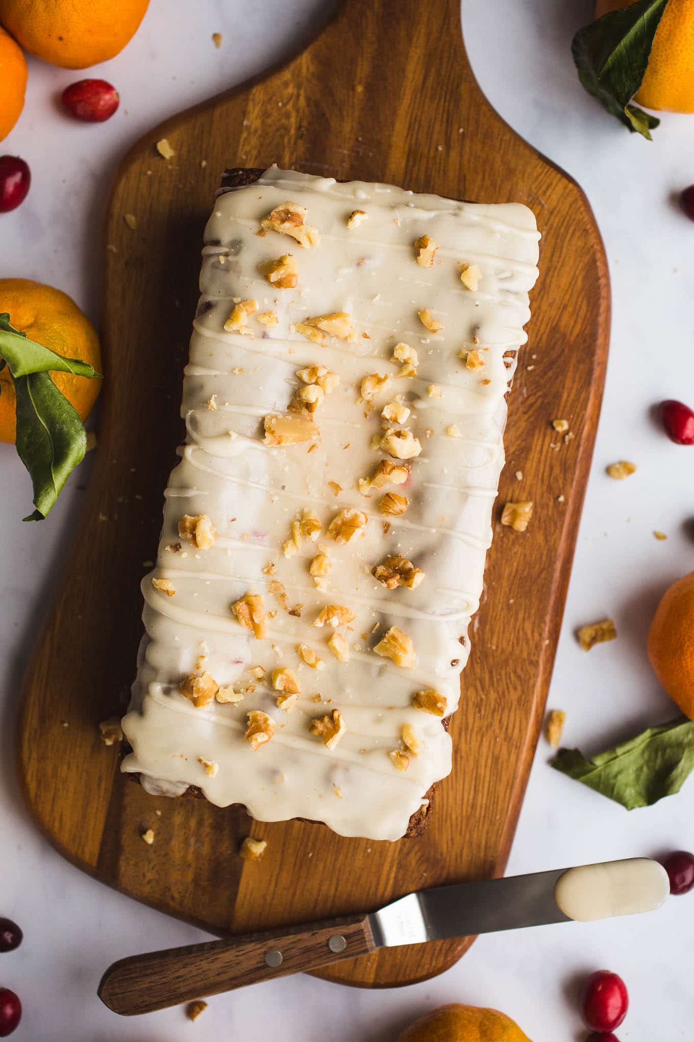 Cranberry orange bread on a wooden platter.