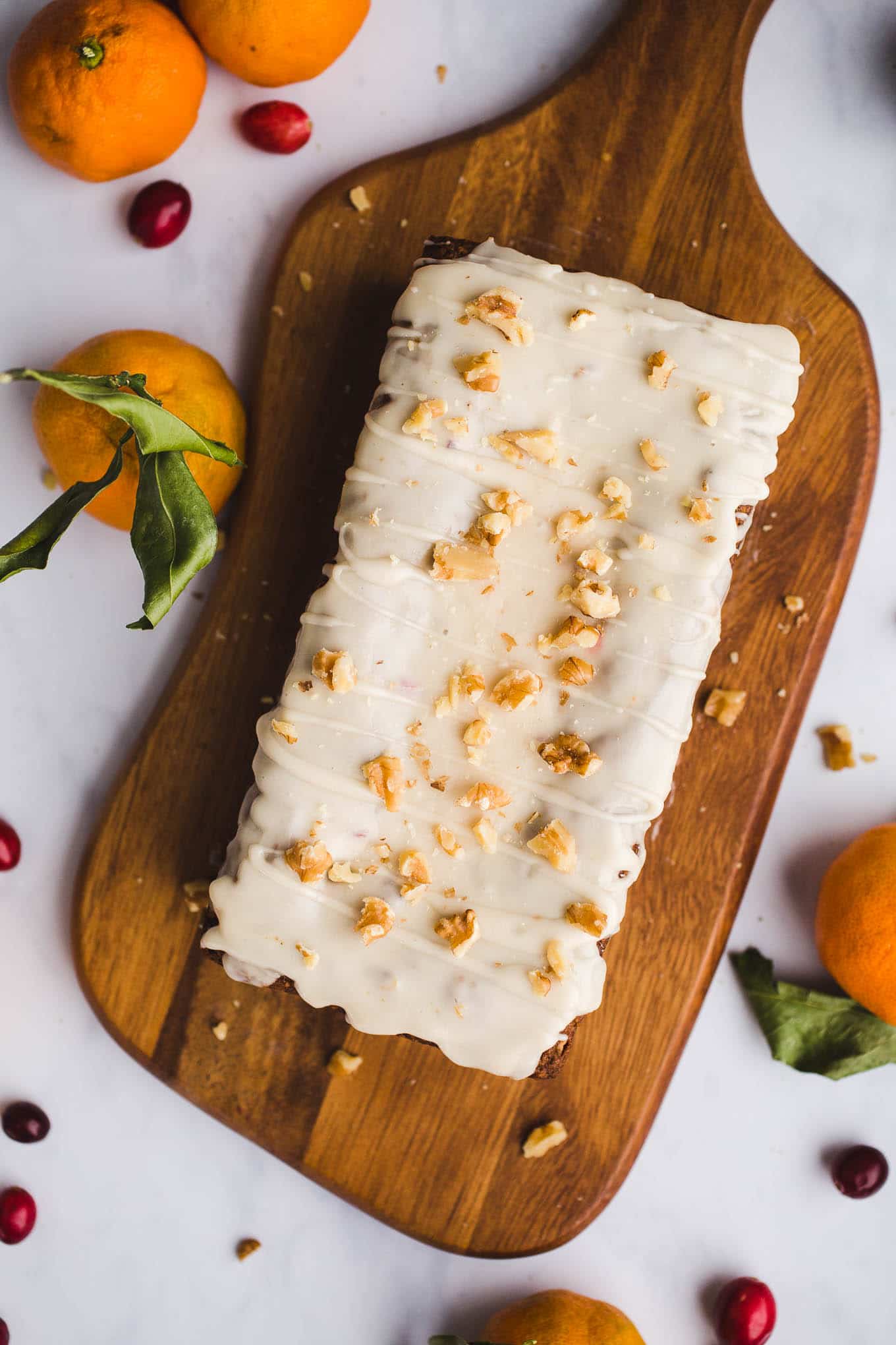 A healthier, moist, Gluten-Free Cranberry Orange Bread with an orange glaze made with almond and oat flours. Vegan. Have it for breakfast or dessert!