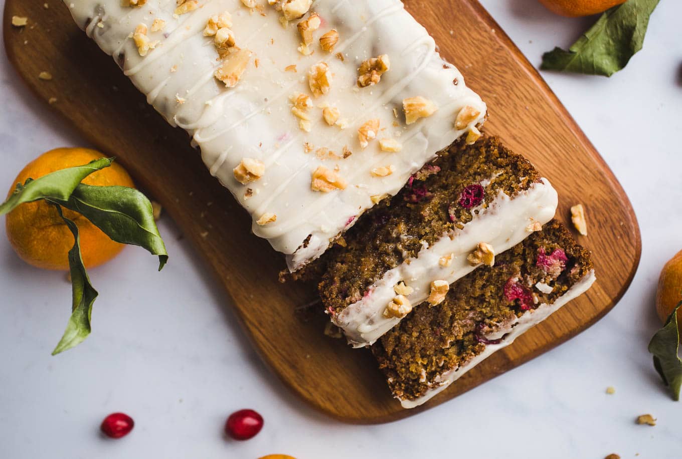 A healthier, moist, Gluten-Free Cranberry Orange Bread with an orange glaze made with almond and oat flours. Vegan. Have it for breakfast or dessert!