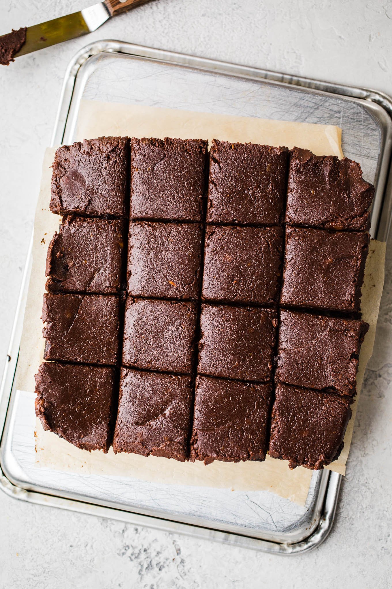 Fudgy brownies on a metal tray. 