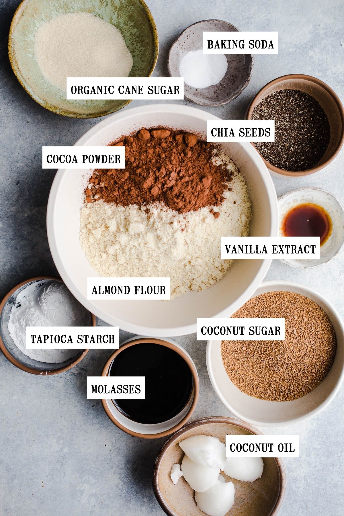 Ingredients to make chocolate molasses cookies in small bowls. 