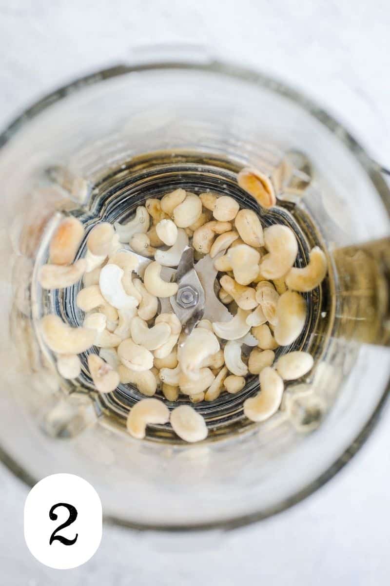 Cashews and water in a blender bowl.