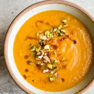 A rustic bowl filled with creamy sweet potato soup.