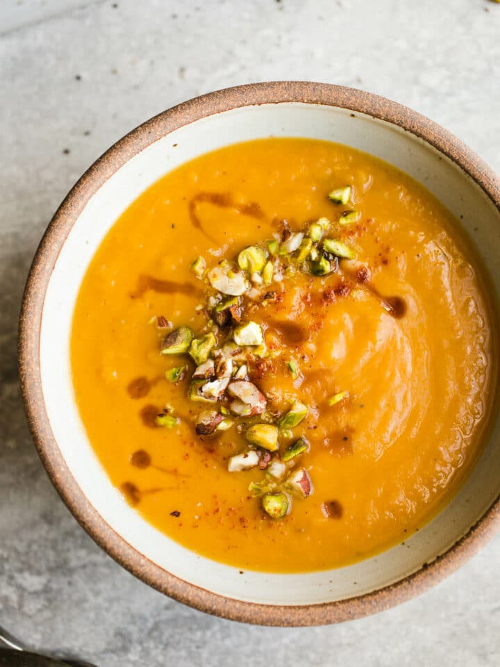 A rustic bowl filled with creamy sweet potato soup.