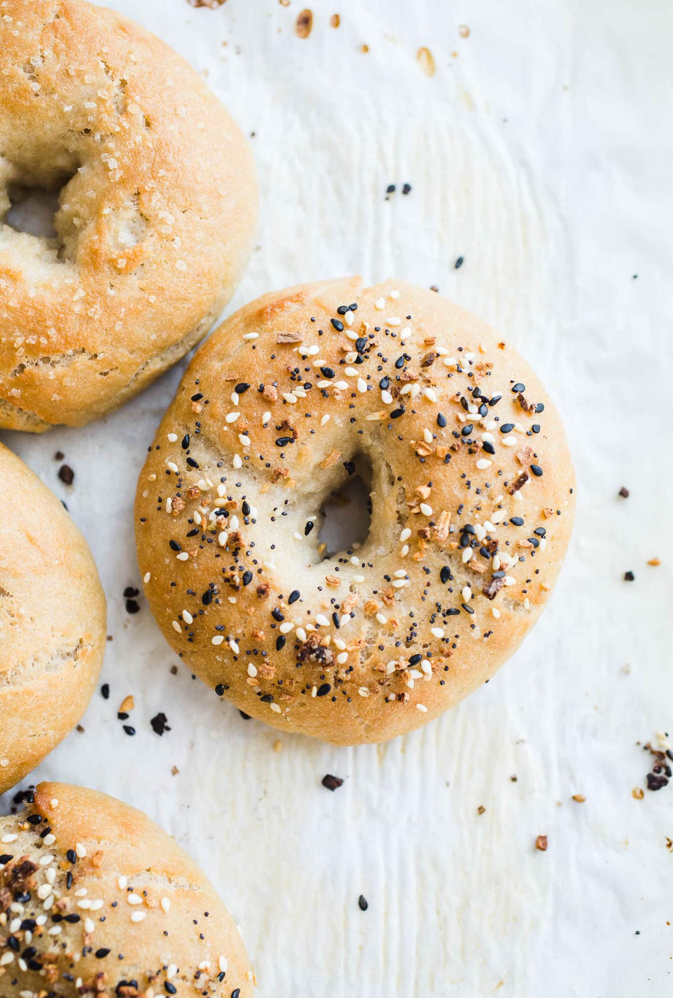 Everything bagels on parchment paper.