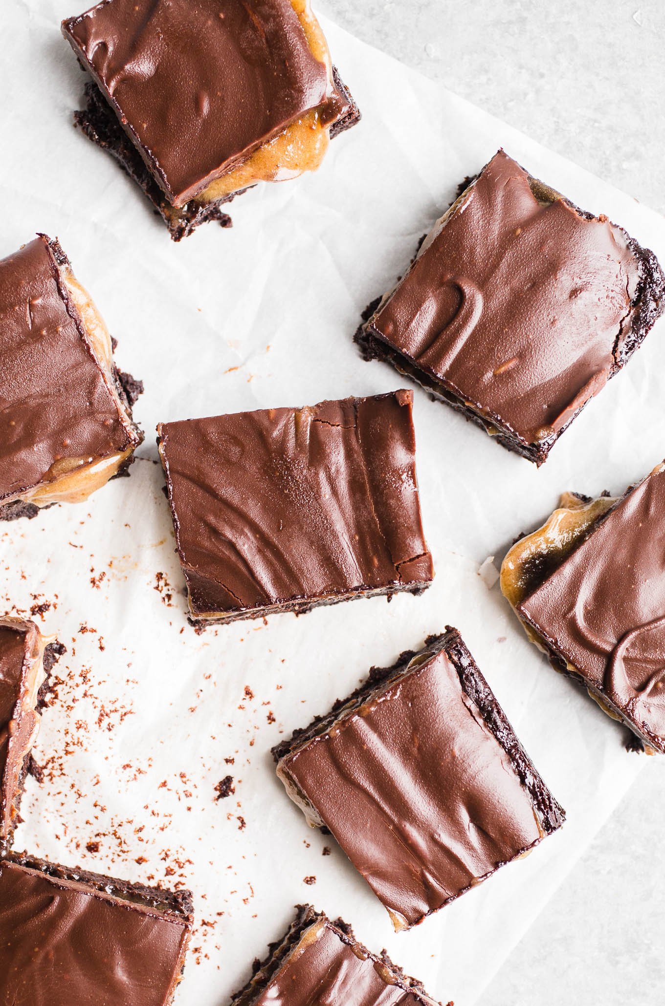 Caramel brownies on parchment paper.