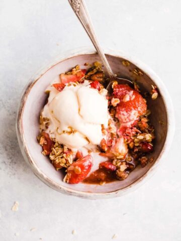A serving of strawberry crisp in a bowl.