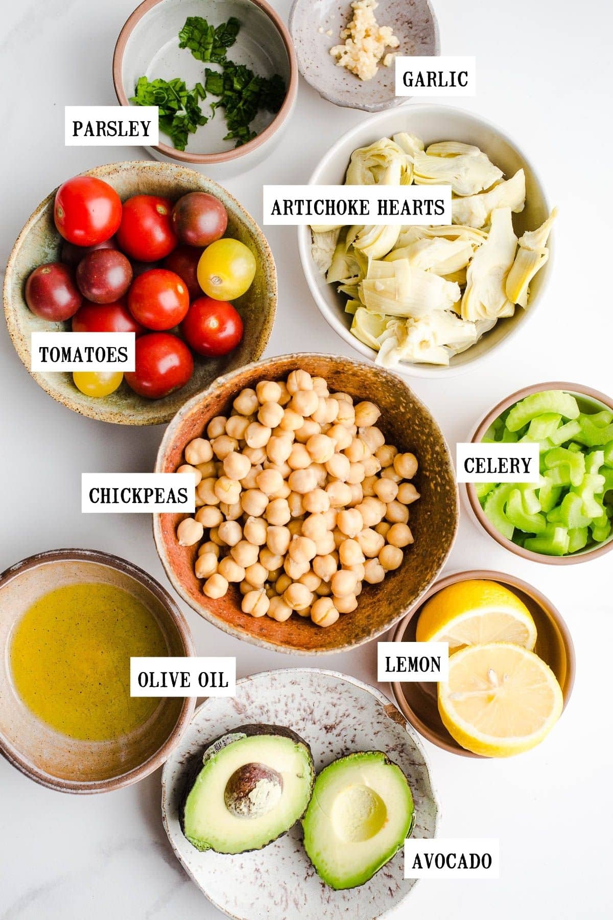 Ingredients to make a garbanzo bean salad in small bowls.