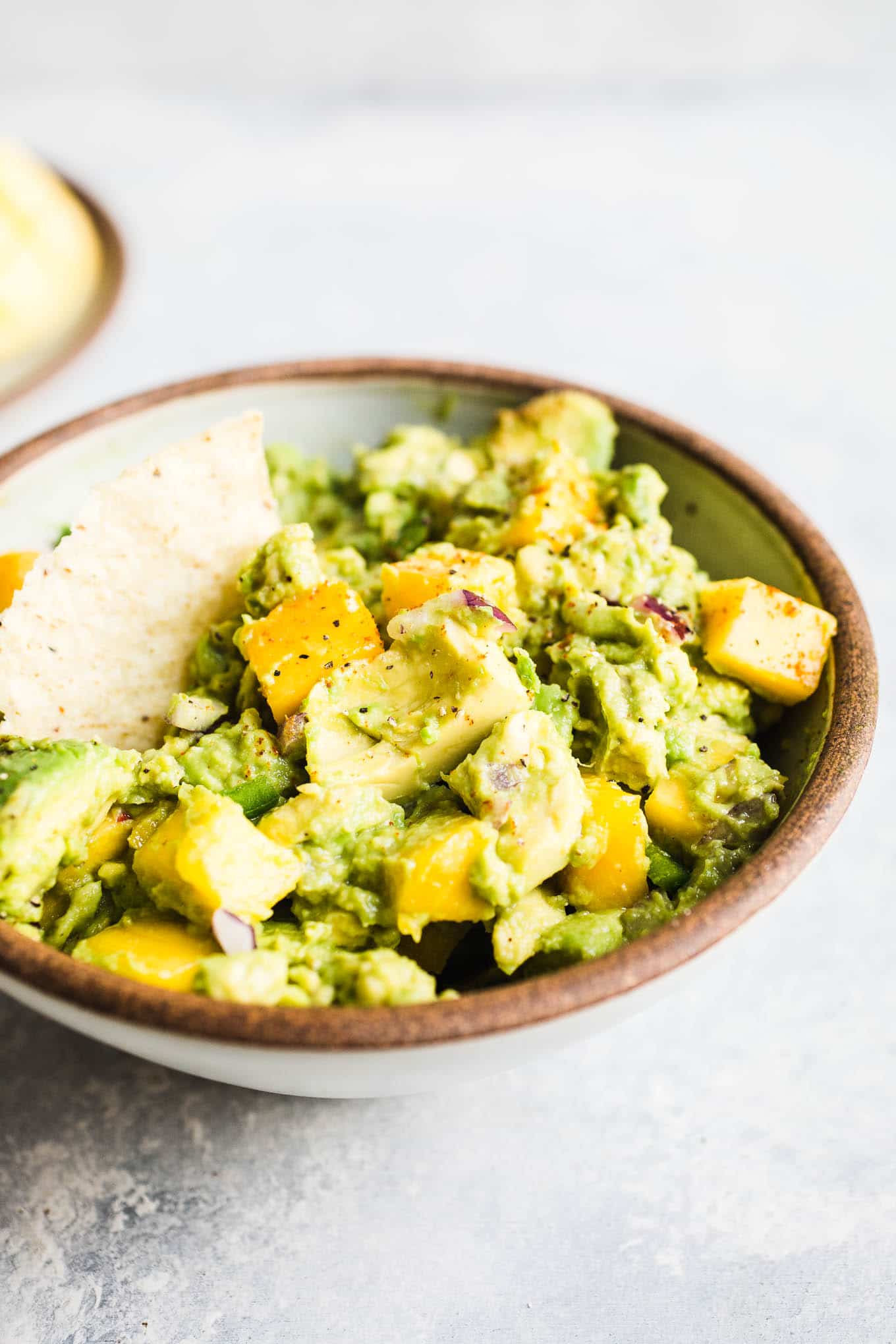 Guacamole with mango in a bowl.