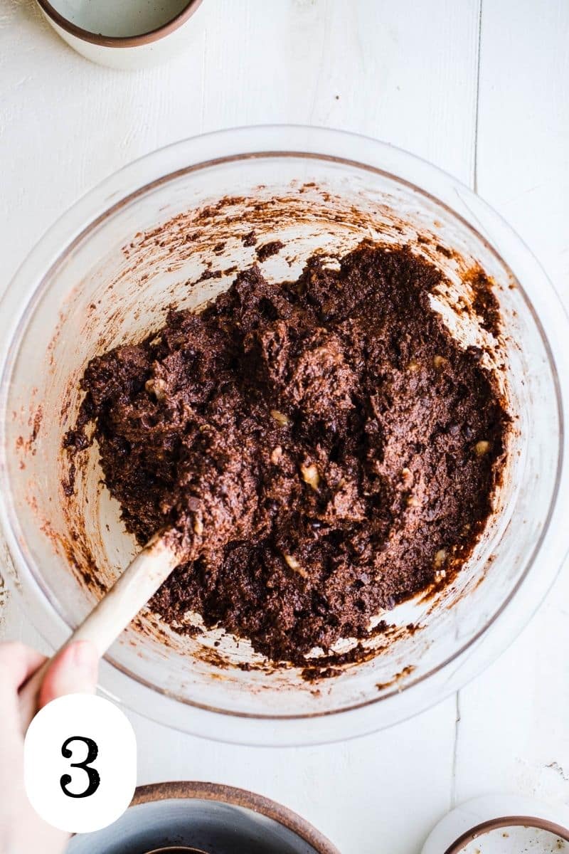 Chocolate banana bread batter in a glass mixing bowl.