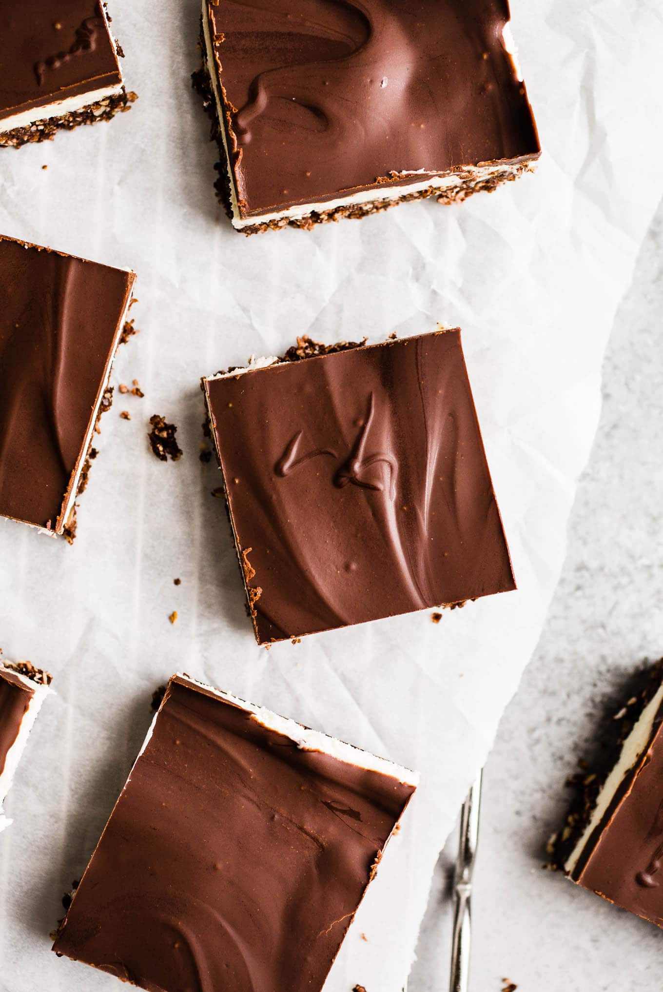 Chocolate squares on a piece of parchment paper.