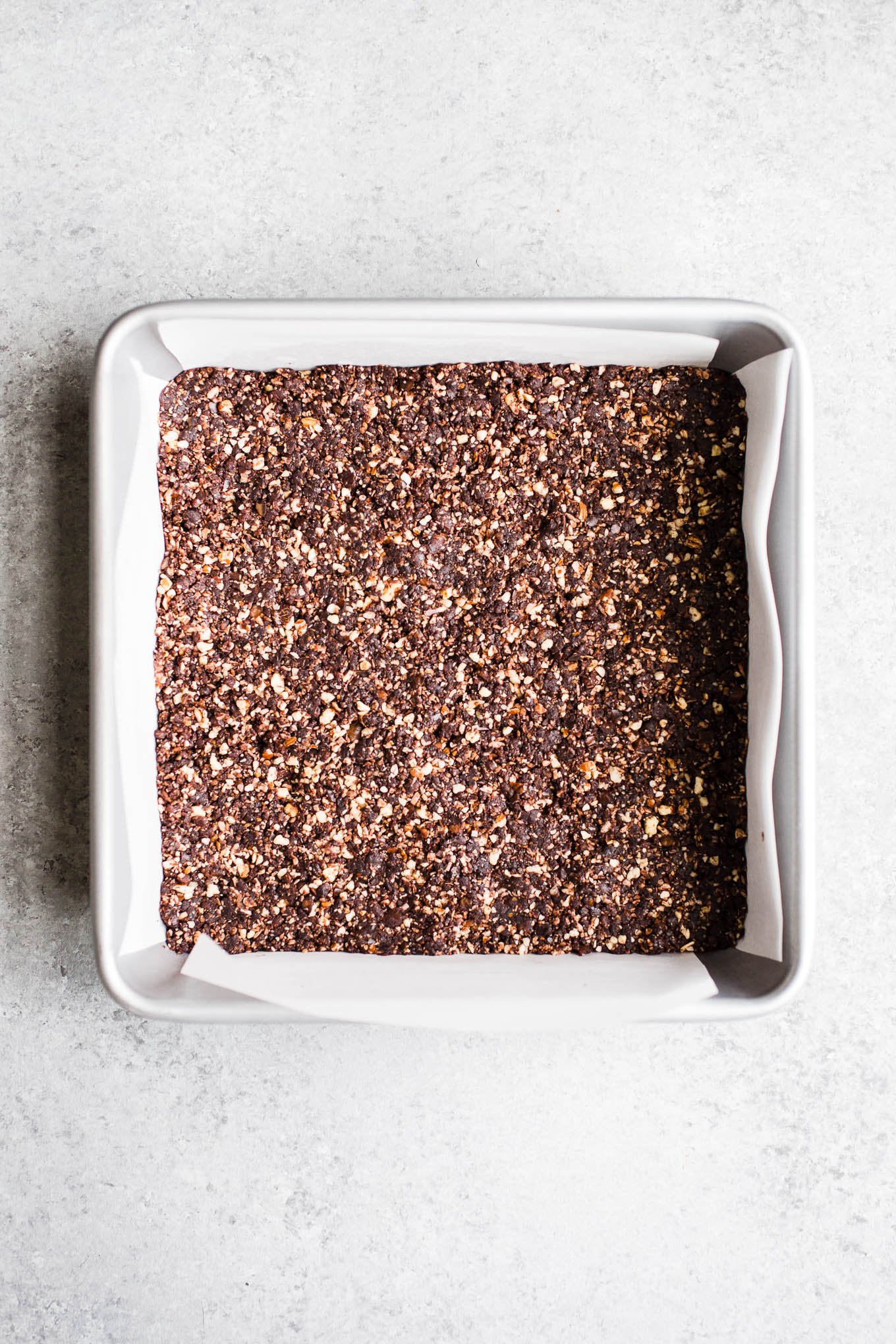 Date and nut mixture pressed into a baking pan.