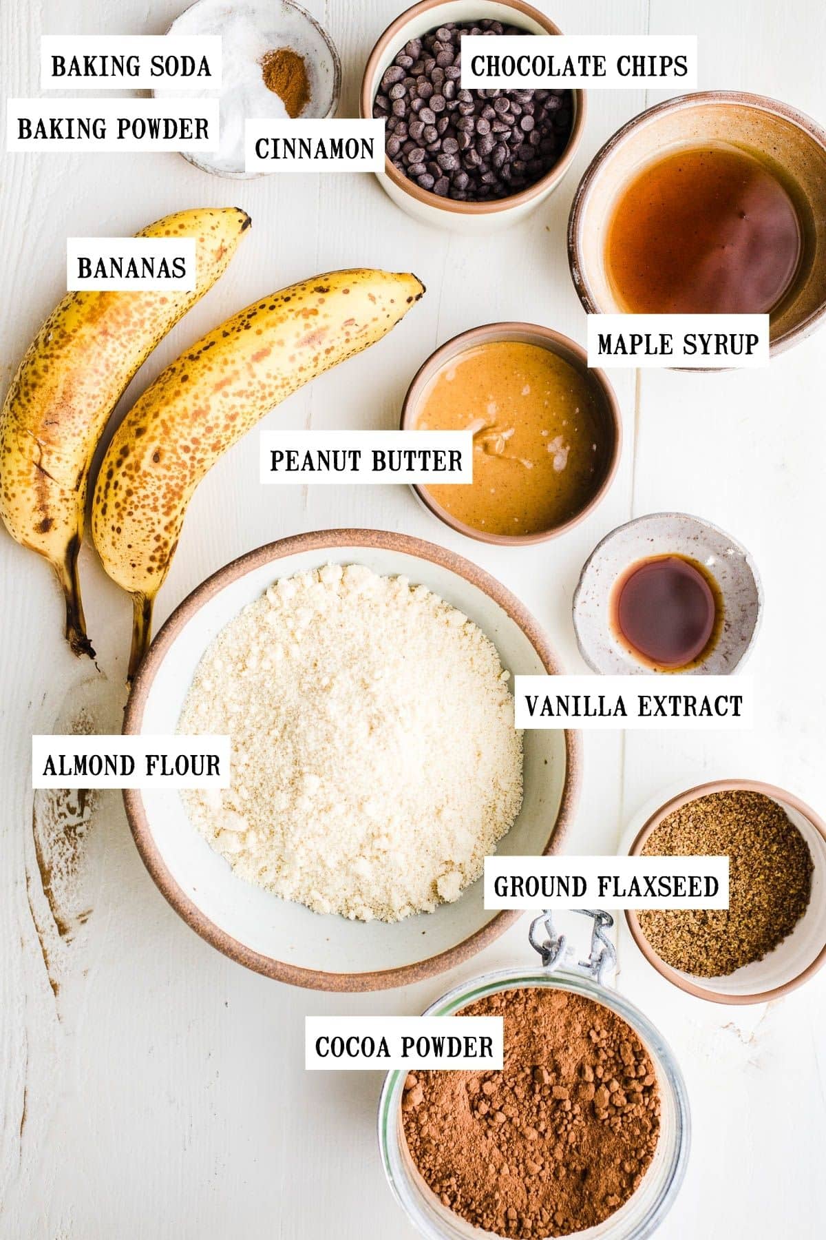 Ingredients for chocolate peanut butter banana bread in separate bowls.