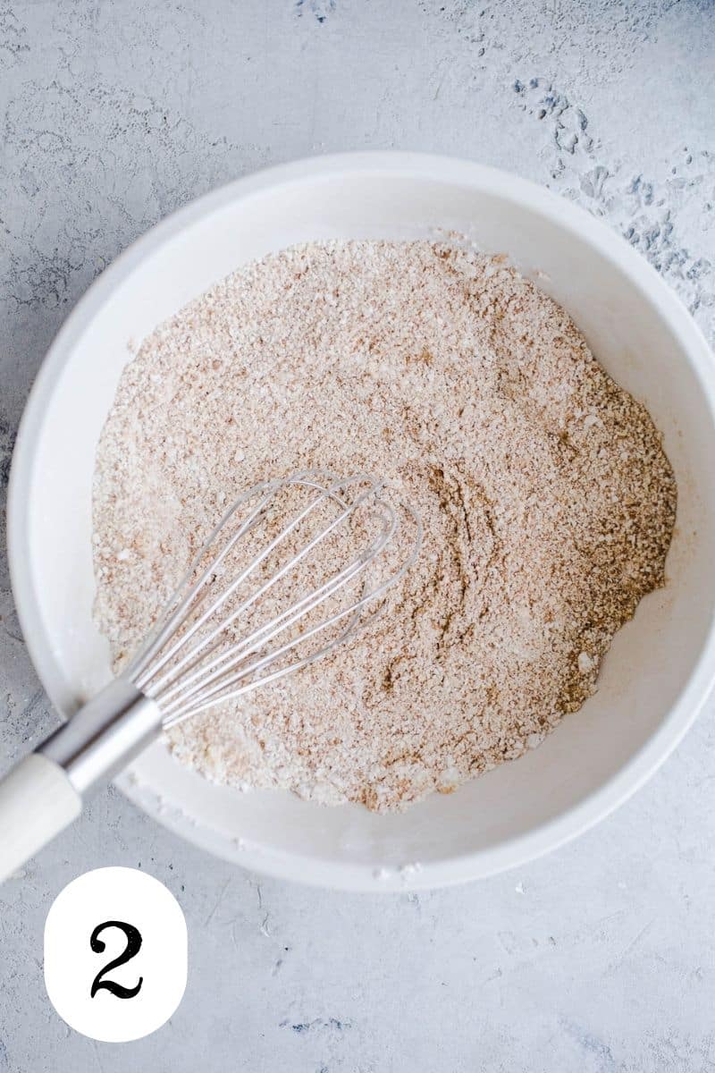 Oat flour and cinnamon in a mixing bowl. 