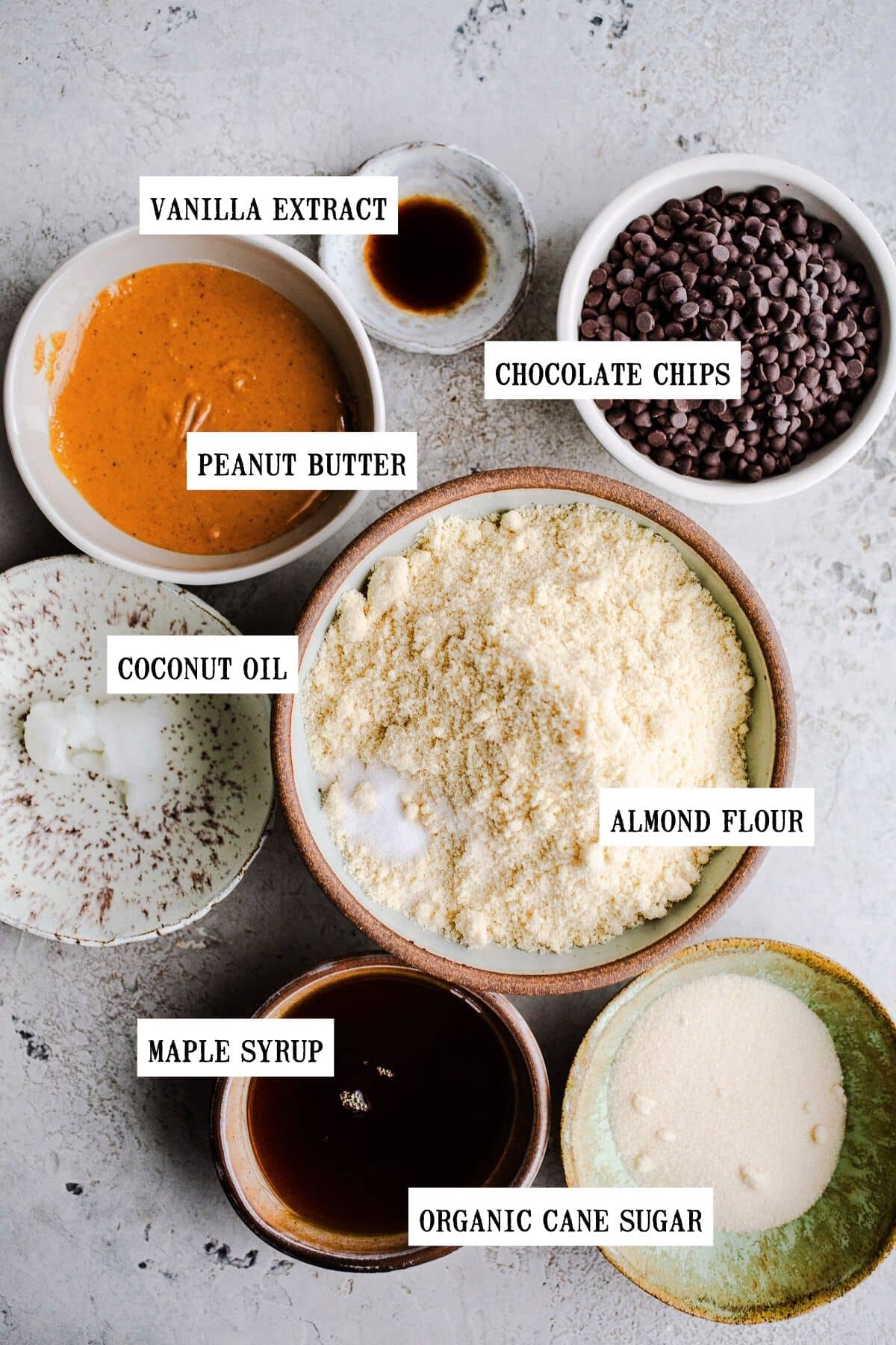 Ingredients to make peanut butter cookies in small bowls. 