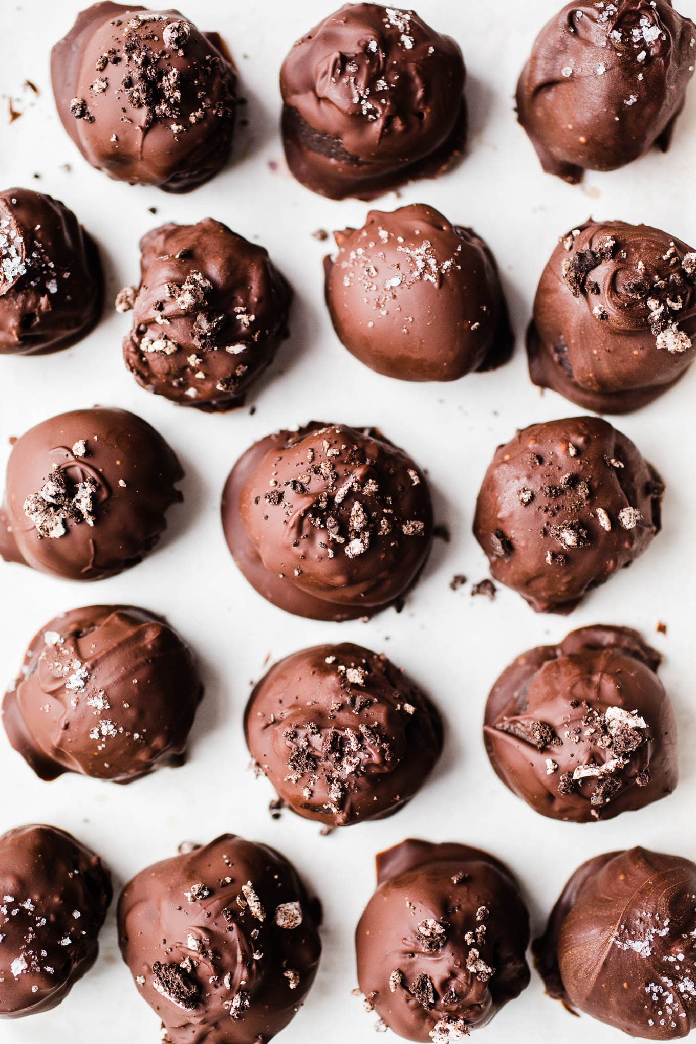 Chocolate dipped Oreo balls on a piece of parchment paper. 