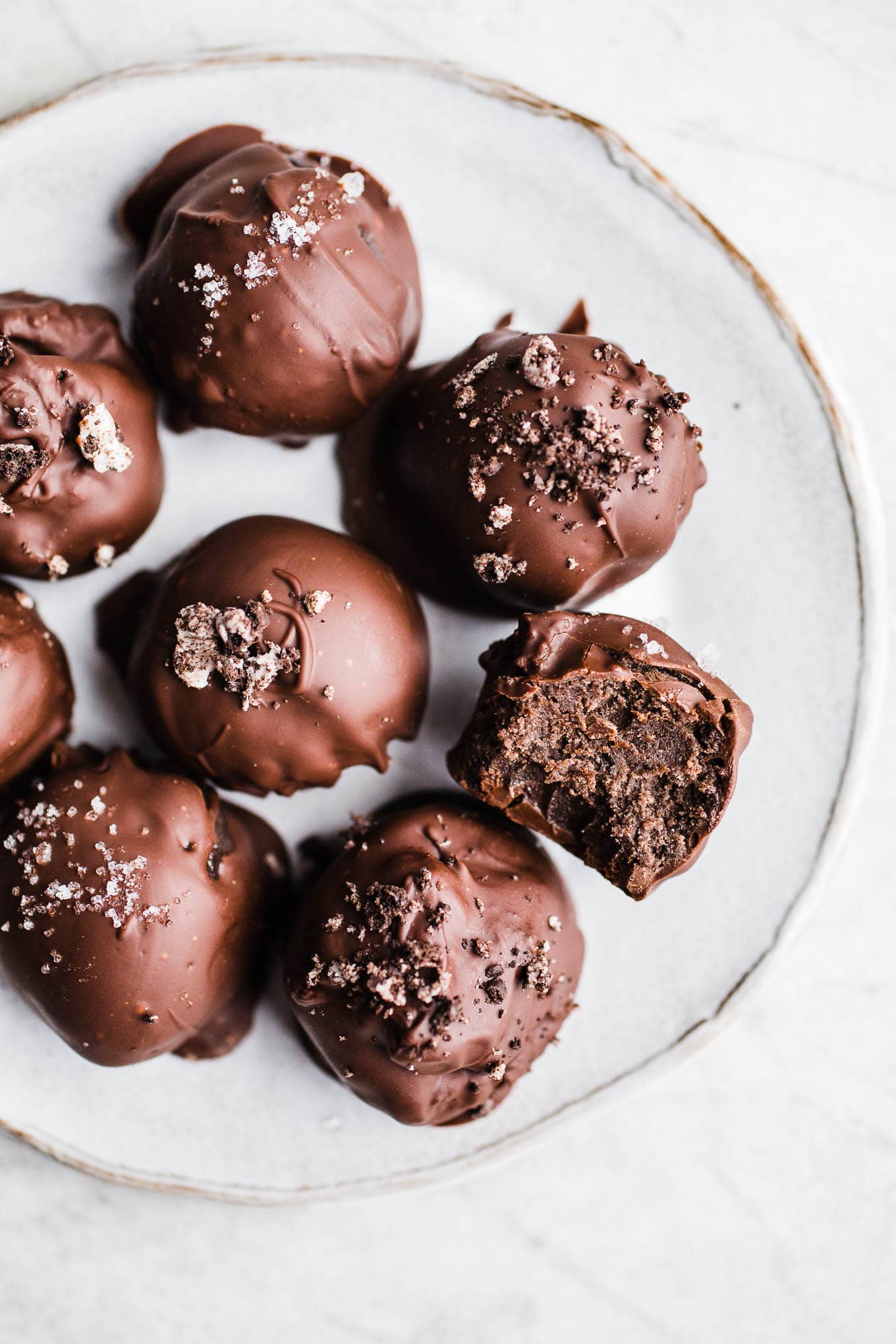 Oreo truffle balls on a white plate.