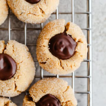 Peanut butter blossoms on a wire rack.